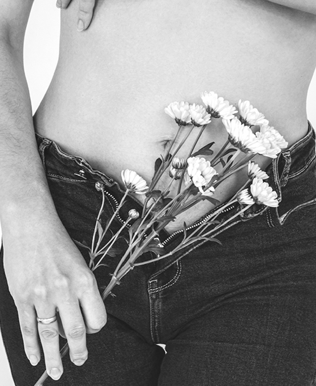 Woman Holding Flowers Against Her Belly