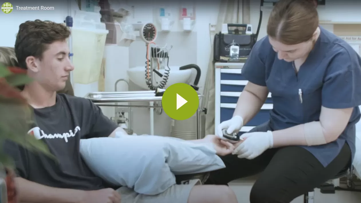 Video thumbnail showing a nurse treating a patient's leg in the treatment room