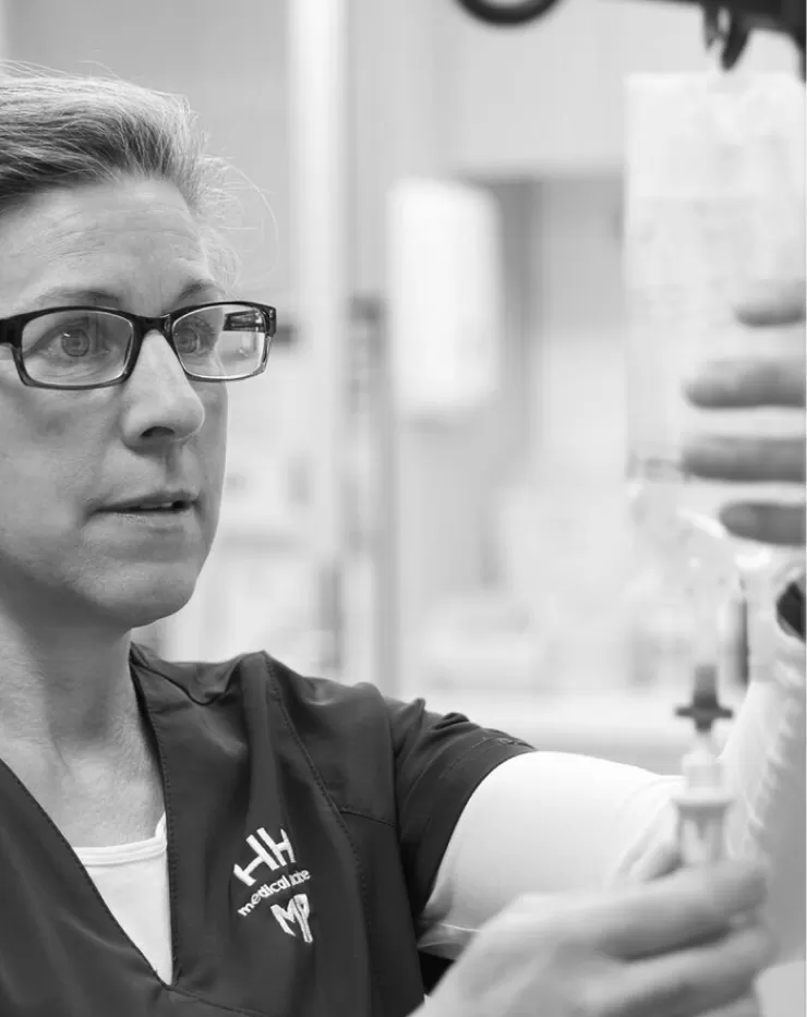 A practice nurse preparing an infusion in the treatment room
