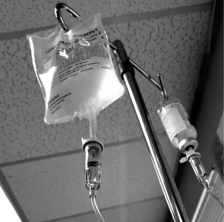 Intravenous infusion bags hanging on a stand in the treatment room