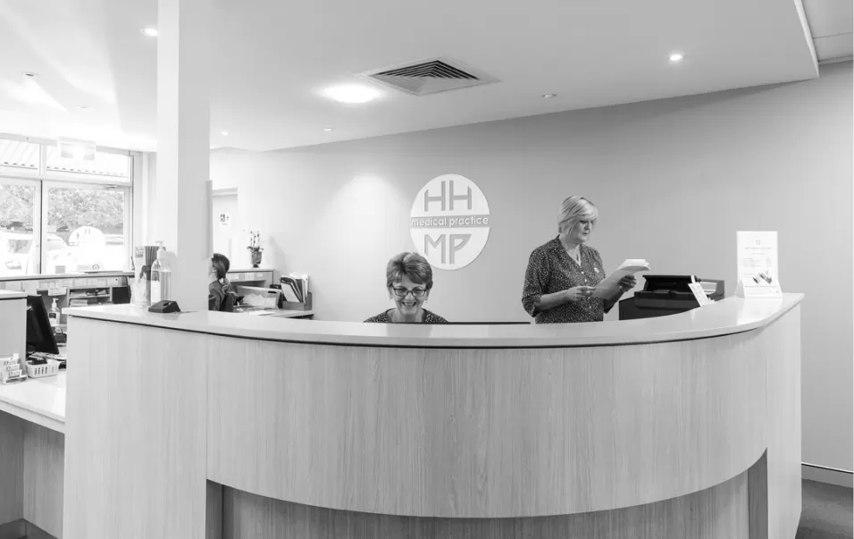 The Hunters Hill Medical Practice reception desk with staff at the counter