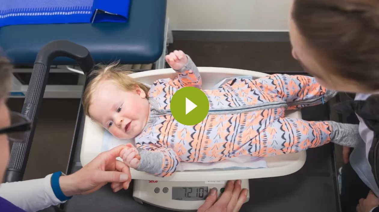 Video thumbnail showing a baby being weighed on clinic scales