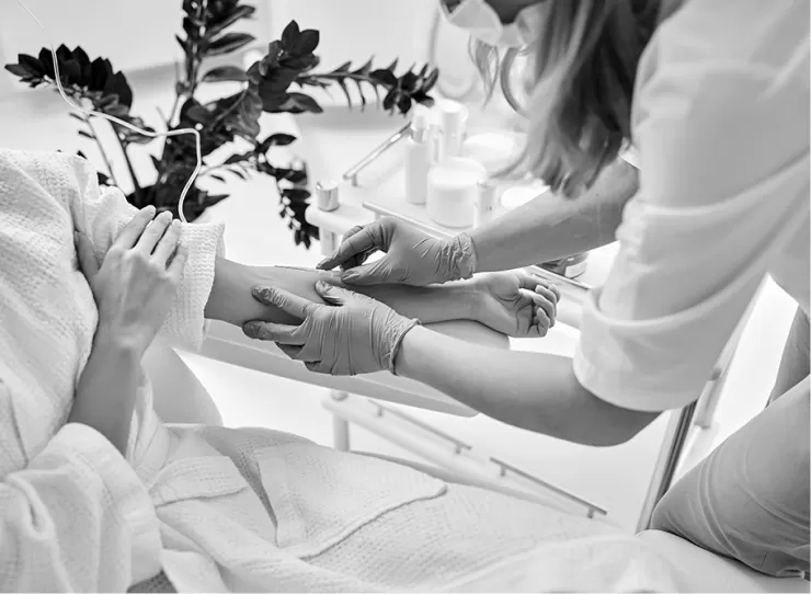 A nurse placing a cannula in a patient's arm for an infusion