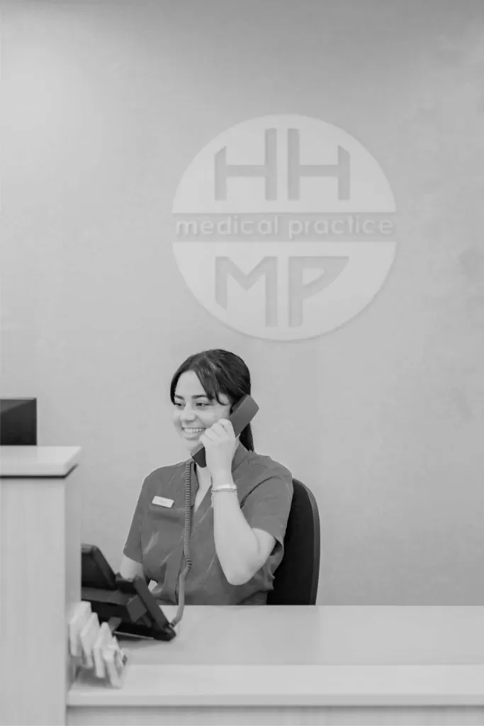 A receptionist taking a call at the Hunters Hill Medical Practice front desk