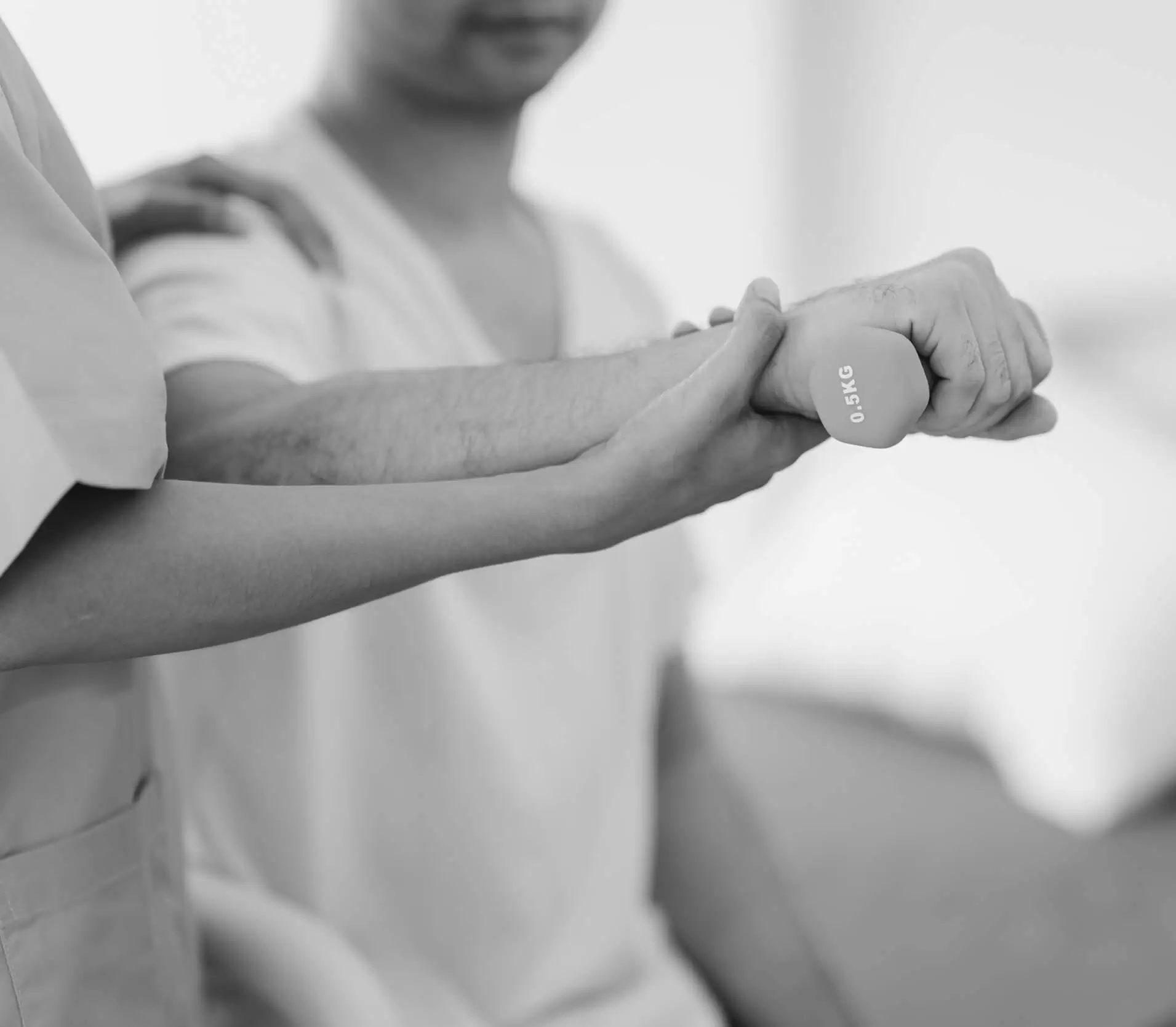 A physiotherapist moving a patient's arm through a range of motion