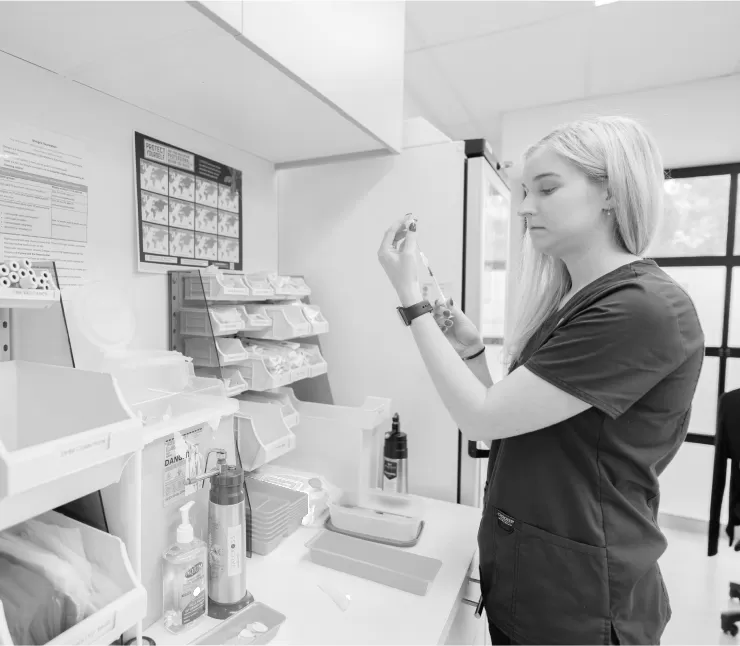 A practice nurse preparing a vaccine in the treatment room