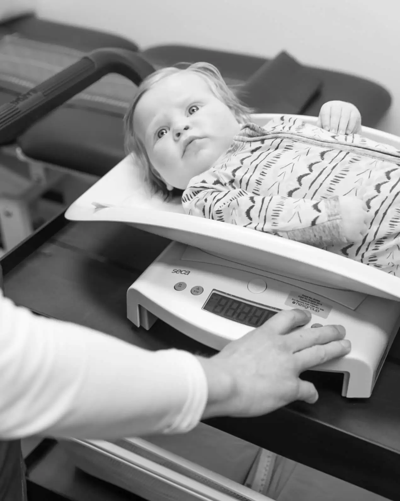 A young child lying on a clinic examination table