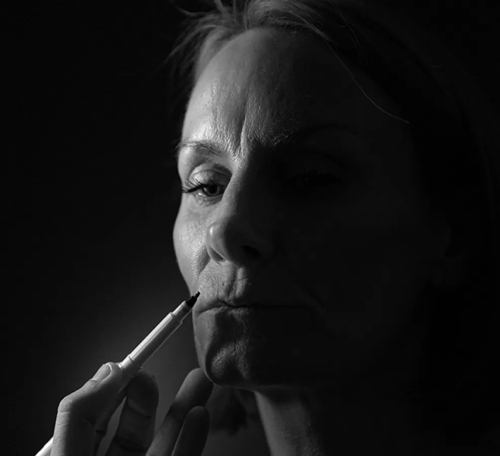 A clinician marking a patient's face before a procedure