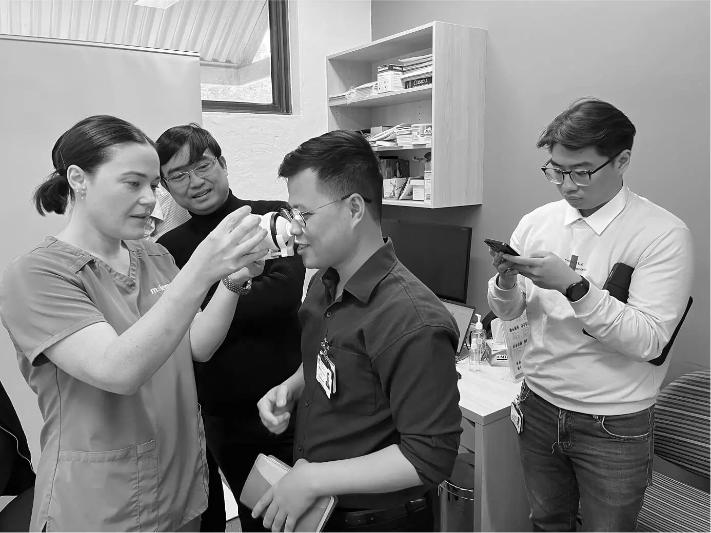 A nurse demonstrating clinical equipment to trainees during a workshop
