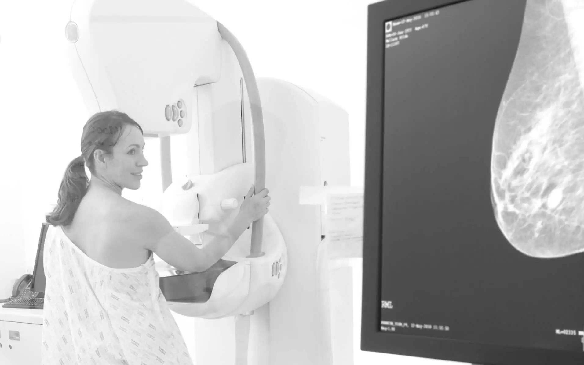 A patient having a mammogram, beside a mammography image