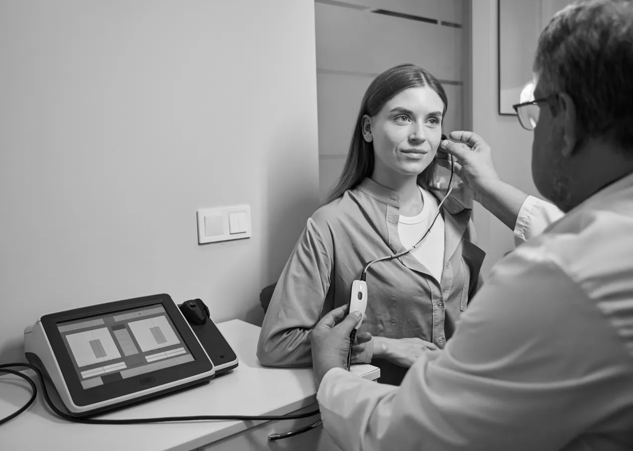 A doctor examining a patient's ear during a workplace medical