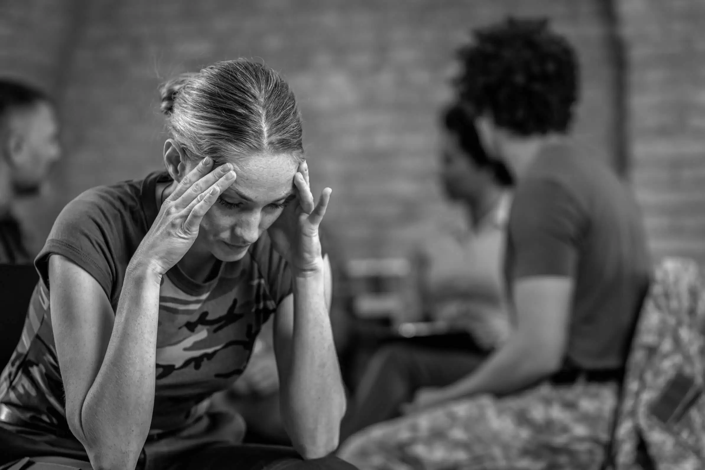 A woman resting her head in her hand during a conversation